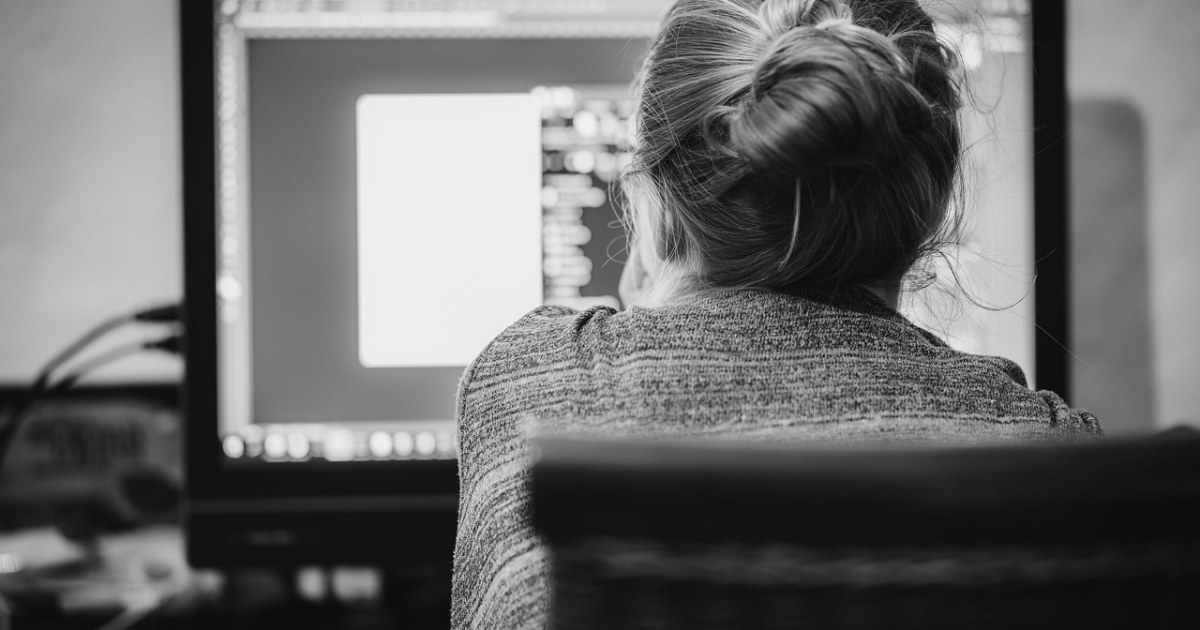 Freelancer working on a laptop in a home office.