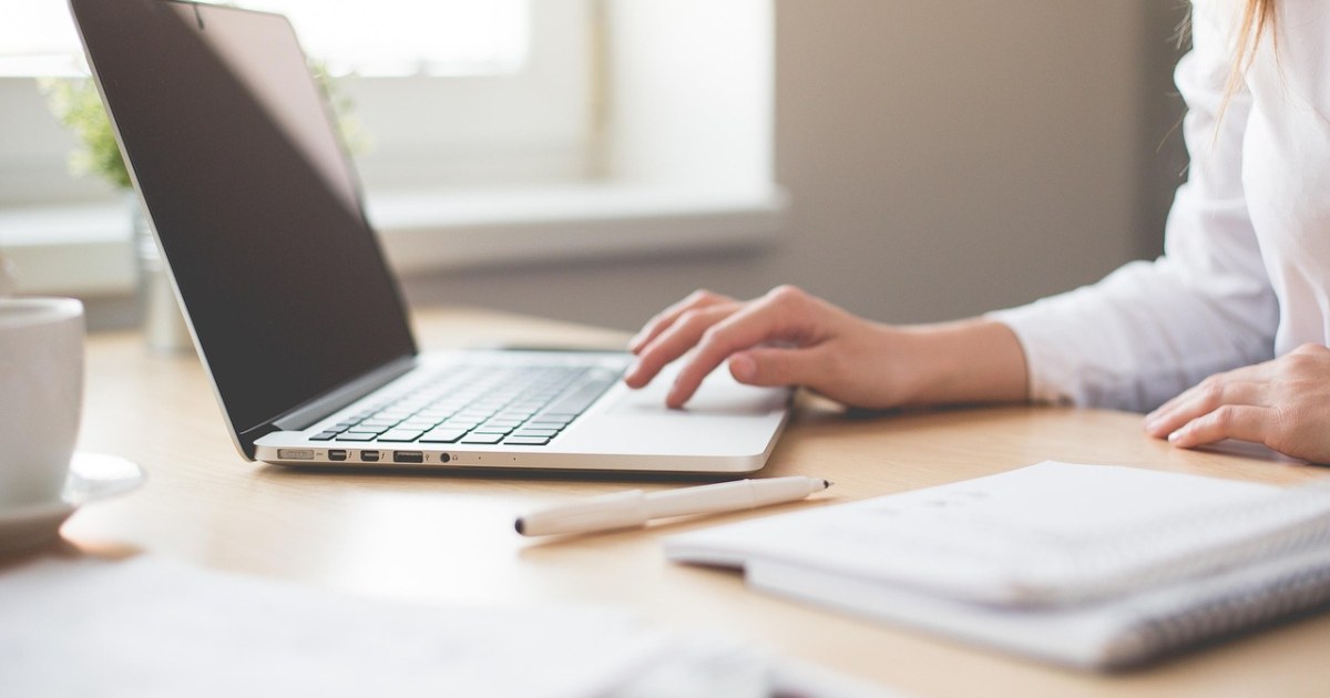 Home office laptop workspace for a solopreneur AI workflow stack guide.