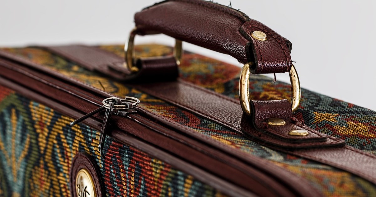 Open suitcase being packed for a carry-on packing list guide.
