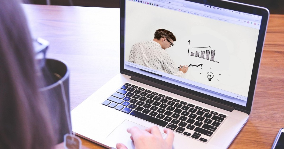 Student using a laptop for an online course guide.