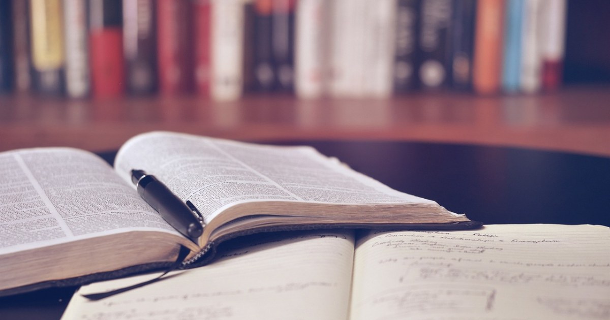 Books and notebook for a personal discovery system guide.