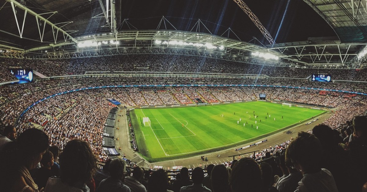 Sports stadium crowd for a traveler choosing a first live sports event.