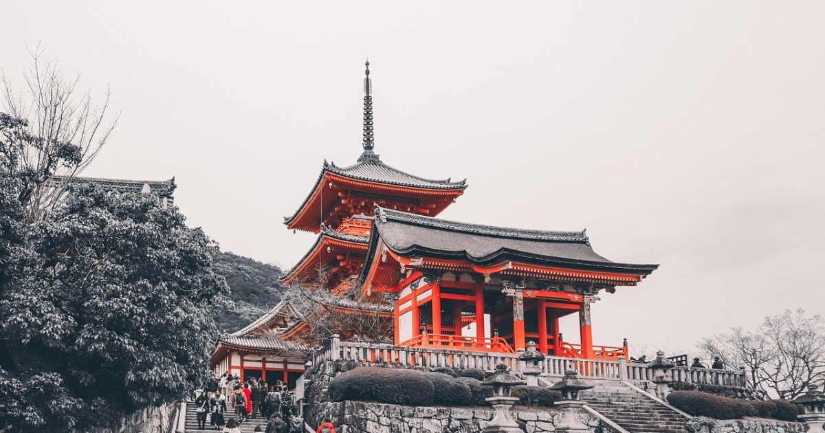 Japanese temple and city travel scene for comparing Tokyo and Kyoto.