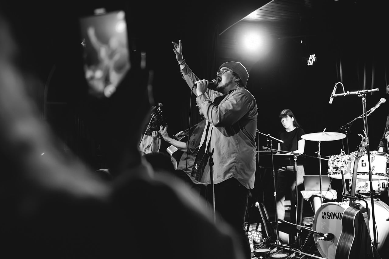 A live band performing on stage, illustrating free concert recordings.