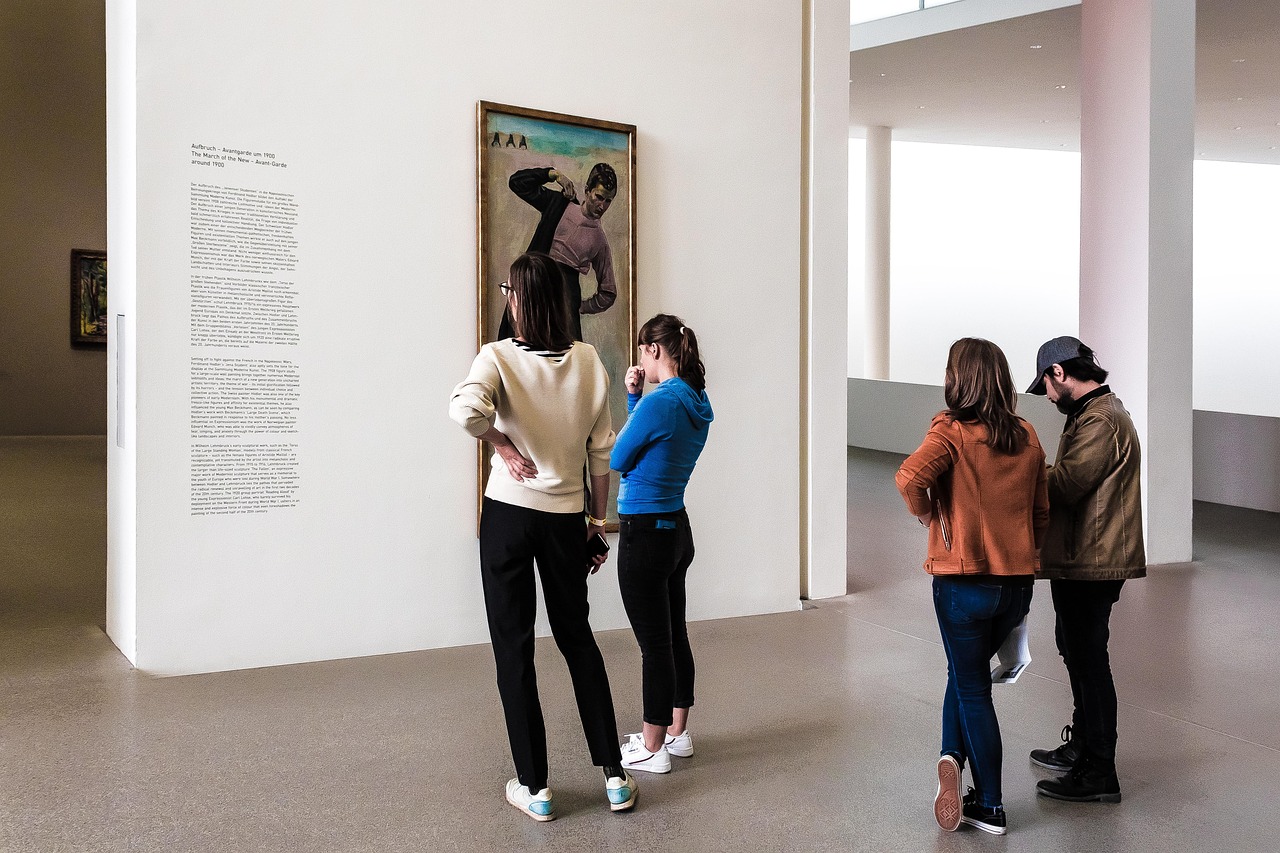 Visitors exploring artworks in a museum gallery, for a guide to online museum collections.