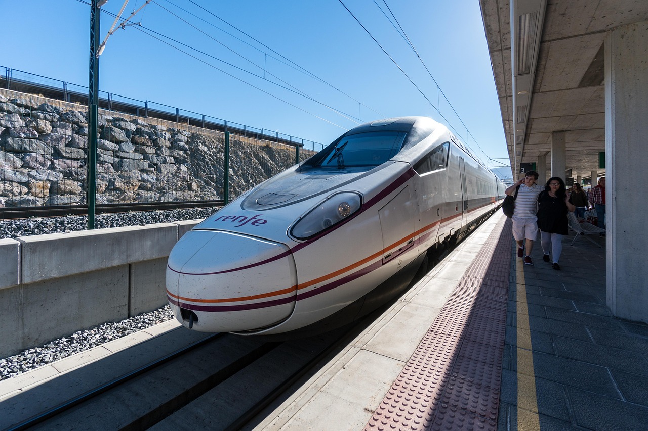 Renfe high-speed passenger train standing at a railway station platform in Spain