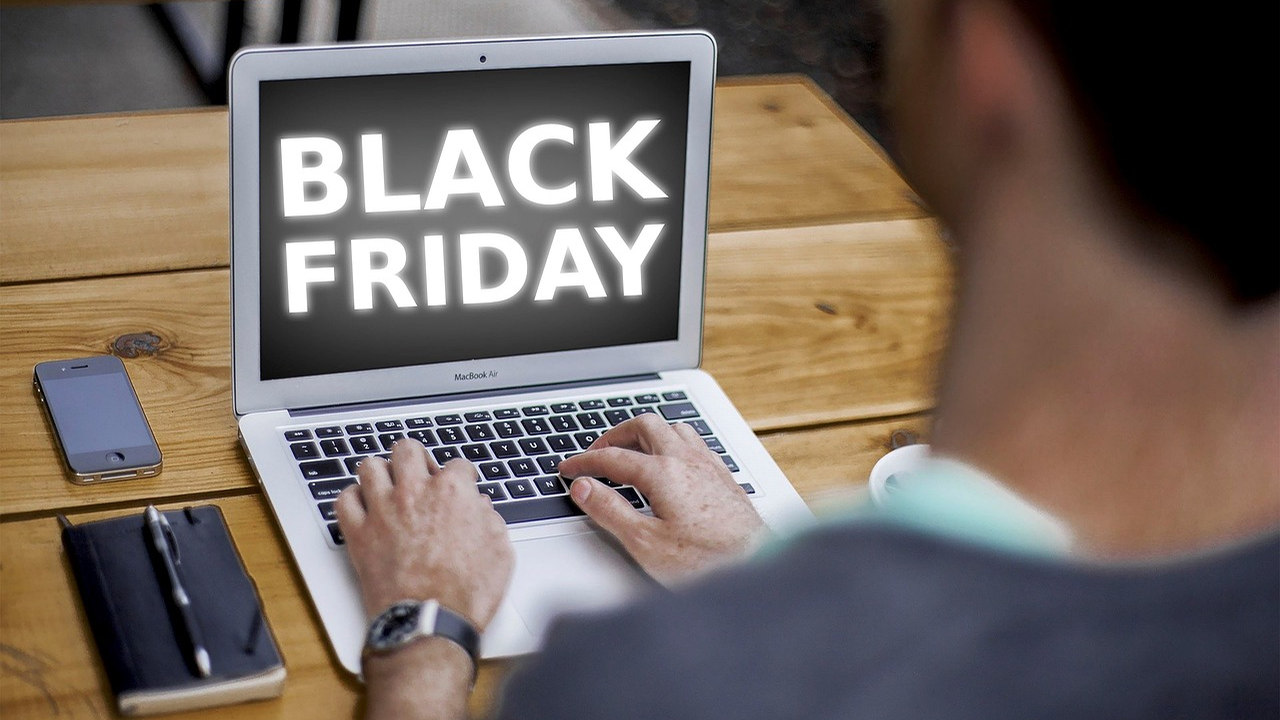Black Friday online shopping displayed on a laptop with a person at the keyboard
